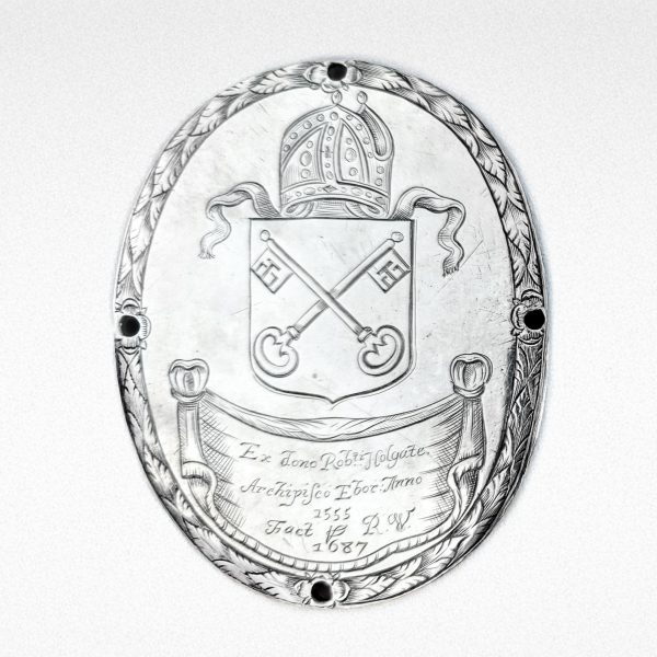Photo of a silver alms badge from 1687.